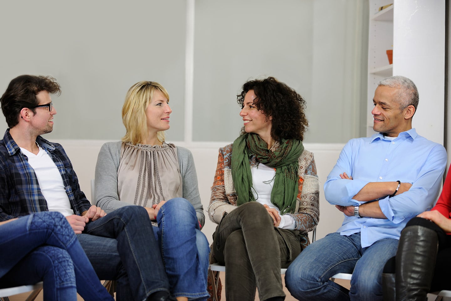 Members of a grief support group sitting together in conversation.