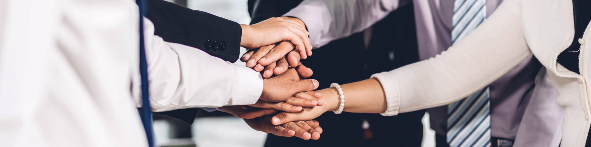 Members of the Trustbridge Foundation team joining hands in a circle