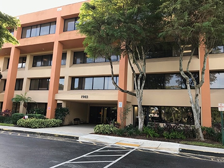 The Boynton Beach office building at 1903 S. Congress Avenue, a three-storey block set among trees
