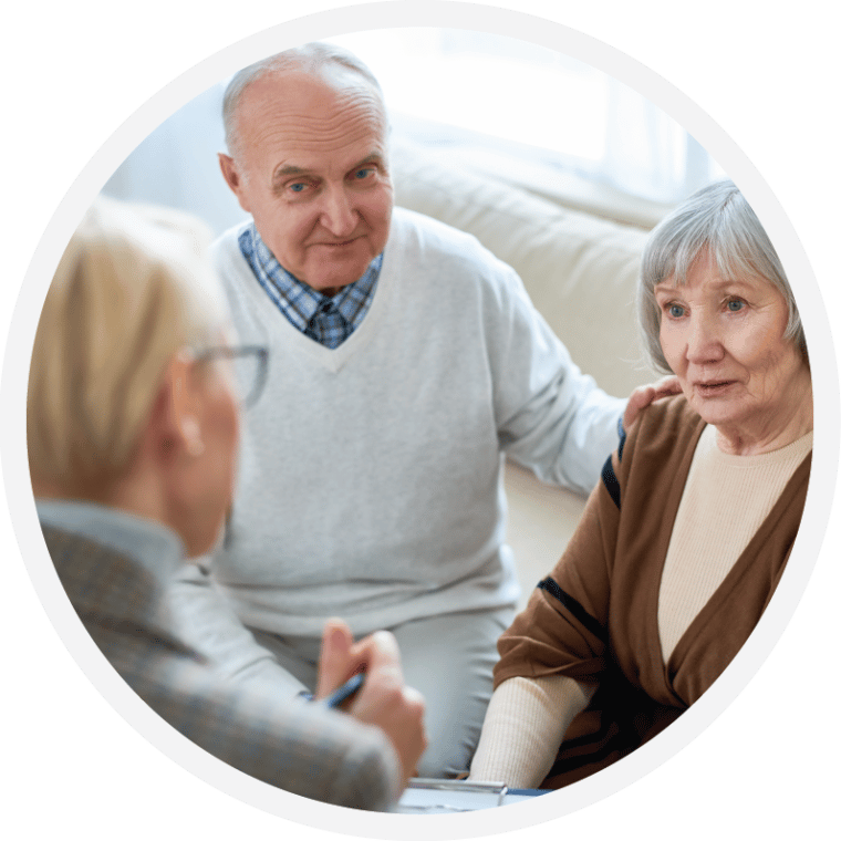 A couple talking with a care professional across a low table
